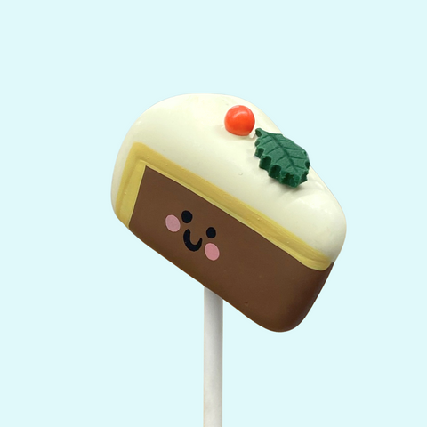 Handmade Christmas cake pop shaped like a mini Christmas cake. - Angle