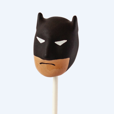 Close-up of a masked hero cake pop with detailed candy melt finish
