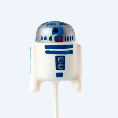 Close-up of a handmade robot cake pop with candy melt coating and detailed design.