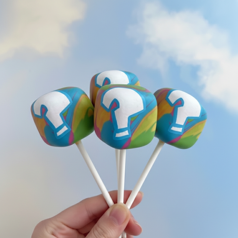 Group of mystery block cake pops arranged for a party dessert table